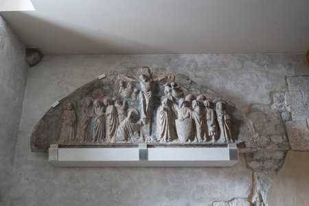 14th century stone lunette depicting the crucifixion kept in the church of Sant'Andrea Apostle in Ve ...のeditorial素材