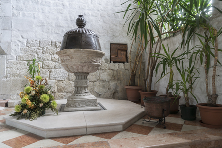 The baptismal font of the sixteenth century in the church of San Andrea in Venzone, Friuli, Italyの写真素材