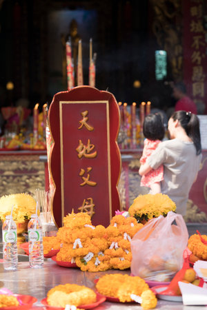 the offerings on the altar in the Chinese temple in Chinatown, Bangkokのeditorial素材