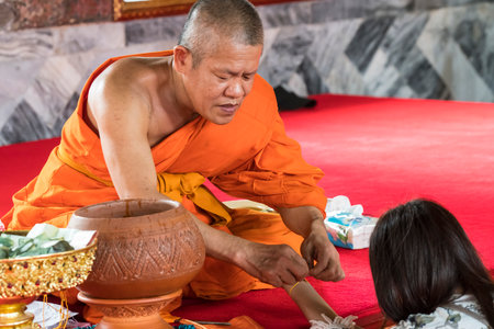 A monk with a faithful in Wat Arun temple in Bangkok, Thailandのeditorial素材