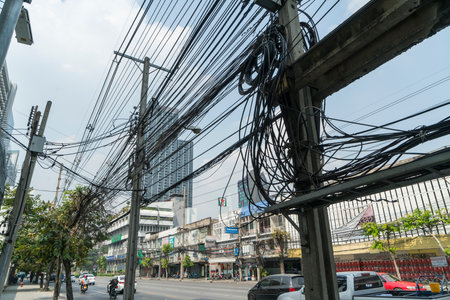 an electrical transformer and cables on the road in Bangkok, Thailandのeditorial素材