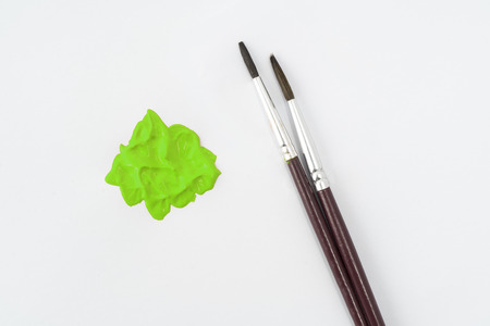 a drop of acrylic green color on a white surfaceの写真素材