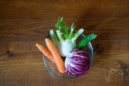 vegetables on a wooden table in the kitchenの写真素材