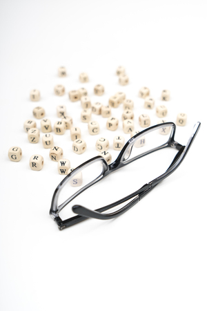 a pair of glasses between the letters of the alphabetの写真素材