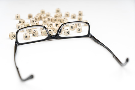 a pair of glasses between the letters of the alphabetの写真素材