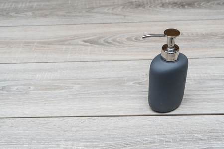 liquid soap dispenser on a wooden tableの写真素材