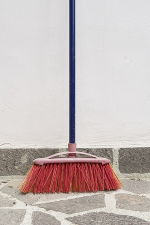 A broom leaning against the wallの写真素材