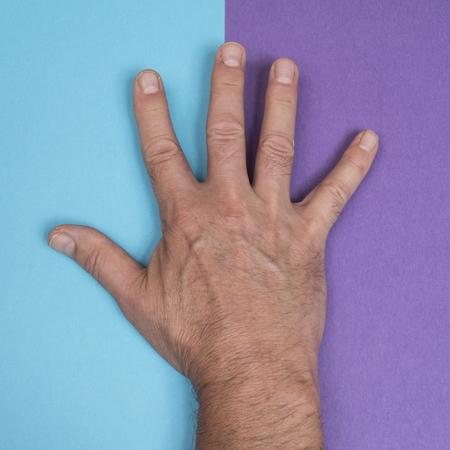 a hand on a two-color surfaceの写真素材