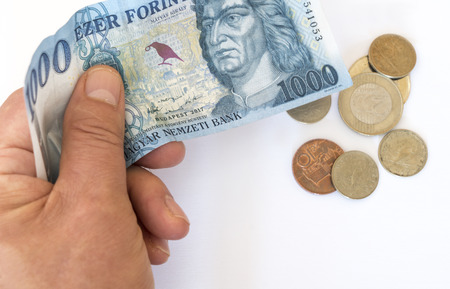 one thousand Hungarian florin banknote with some coins