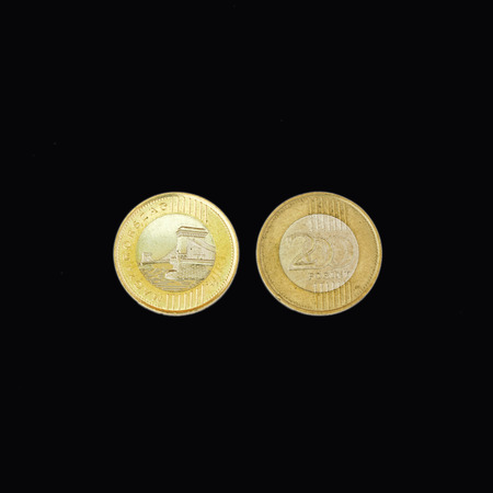 front and back of a coin of 200 Hungarian forints on a black backgroundの写真素材