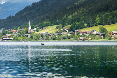 a couple relaxes on a boat at Lake Weissensee, Austriaのeditorial素材