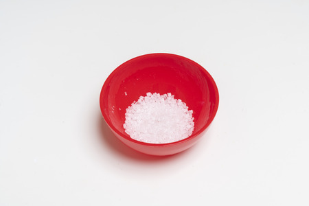 a bowl containing coarse saltの写真素材