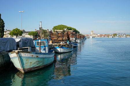 Some fishing boats moored on the pier of the port of Marano Lagunare, Friuli Venezia Giulia Region, Italyのeditorial素材