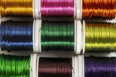 Some  spools of colored metallic threadの写真素材