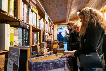two women while they buy books in a bookstoreのeditorial素材