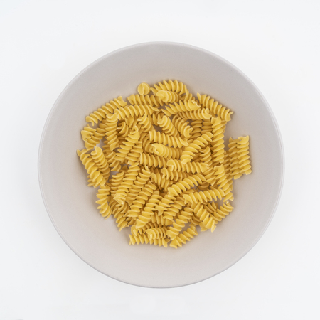 dried Fusilli pasta on a plateの写真素材