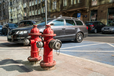 Warsaw, Poland. April 2019.   two hydrants on the sidewalk of a city center streetのeditorial素材