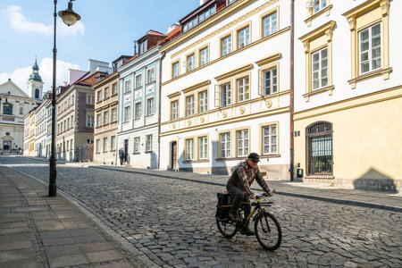 Warsaw, Poland. April, 2018.   man on a bicycle on a street in the old cityのeditorial素材