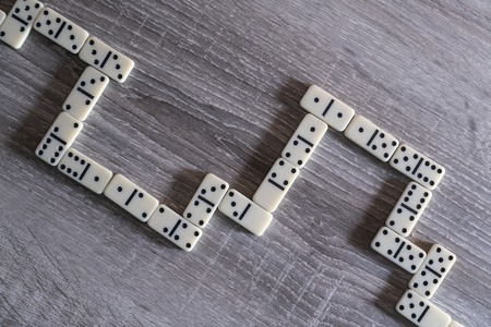 the pieces of the game of dominoes on the wooden tableの写真素材