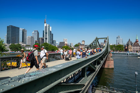 Frankfurt, Germany. July 2019.   Some tourists cross the iron bridge over the river Mainのeditorial素材