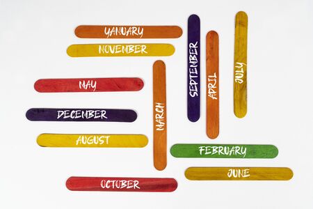 the months of the year written on colored wooden palletsの写真素材