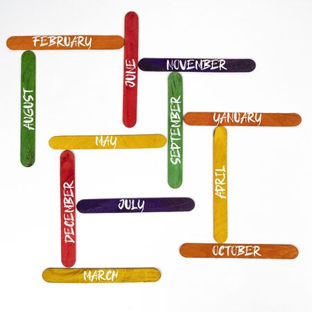 the months of the year written on colored wooden palletsの写真素材