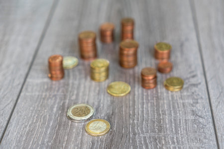 Udine, Italy, July 17, 2019.  some stacks of euro coins on a wooden tableのeditorial素材