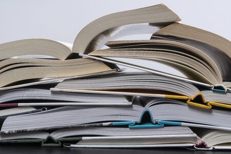 a stack of open books with a white background