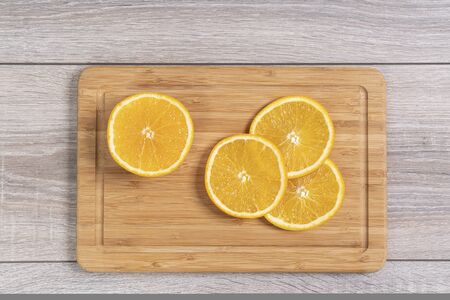 Some orange slices on a wooden boardの写真素材