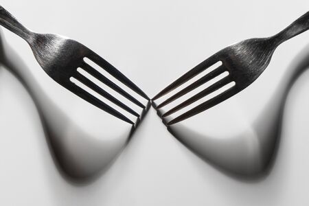 the drawing of the shadows of the forks on a white surfaceの写真素材