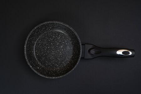 An empty  pan on a black  surfaceの写真素材