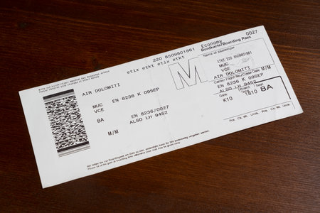 the boarding pass of the Air Dolomiti  airline on a wooden tableのeditorial素材