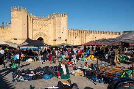 Fez, Morocco. November 9, 2019.  the stands of clothing vendors in the large Place Boujloud