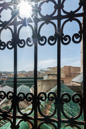 Fez, Morocco. November 9, 2019.  the view of the city through the decorated metal grille of the Al Attarine Madrasaのeditorial素材