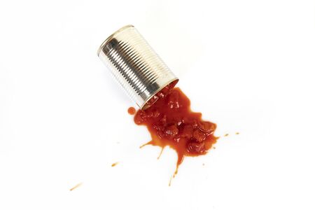 a jar of tomato sauce on a white surface
