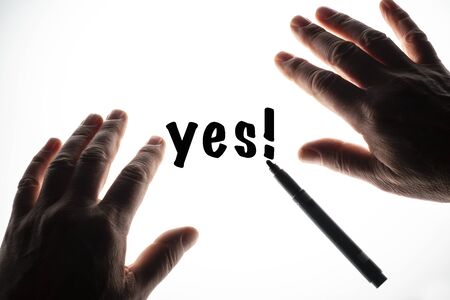 the word Yes written on a backlit surfaceの写真素材