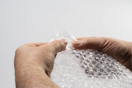 a sheet of plastic bubble padding in your handsの写真素材