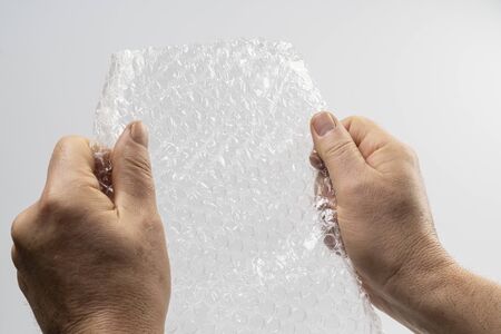 a sheet of plastic bubble padding in your hands
