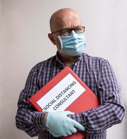 the portrait of a consultant for social distancing with a folder in handのeditorial素材