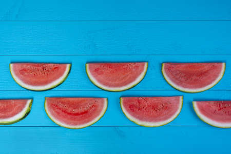 a watermelon cut on a white surface