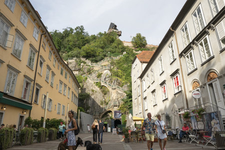 Graz, Austria. August 2020. The shadow of two lovers kissing under the clock tower at nightのeditorial素材