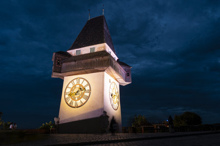 Graz, Austria. August 2020. The shadow of two lovers kissing under the clock tower at nightのeditorial素材