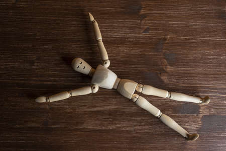 a wooden mannequin lying in relaxationの写真素材