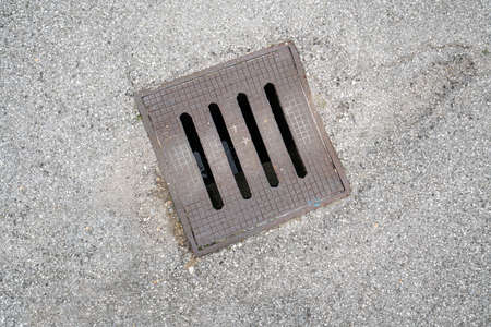 a sewer manhole in the streetの写真素材