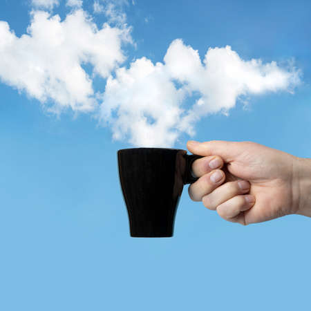 The clouds in the sky like steam rising from a cup of coffeeの写真素材