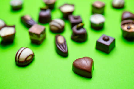 some small chocolates decorated on a colored surfaceの写真素材