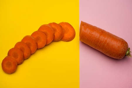 Carrot halves cut into slices on a colored surfaceの写真素材