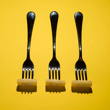 three forks with rigatoni pastaの写真素材
