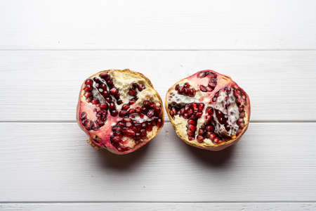 a pomegranate on a white wooden table