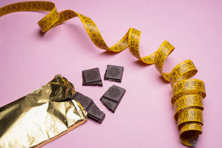 a tape measure between some cookies on a colored surface.の写真素材